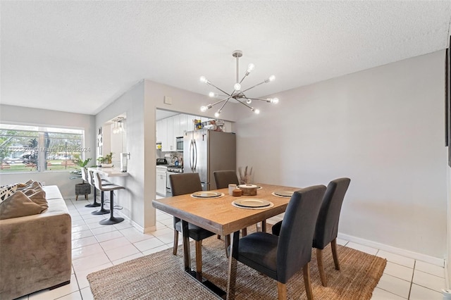 tiled dining space featuring a textured ceiling and a notable chandelier