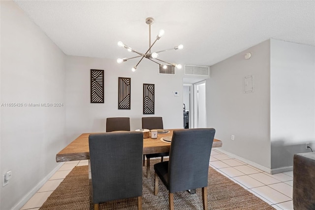 dining room with a notable chandelier, a textured ceiling, and light tile patterned flooring