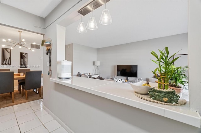 interior space featuring light tile patterned floors and an inviting chandelier