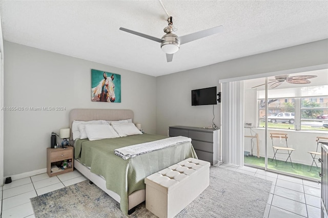 bedroom featuring a textured ceiling, ceiling fan, and light tile patterned floors