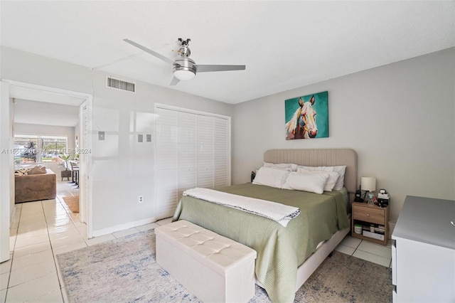 tiled bedroom with a closet and ceiling fan