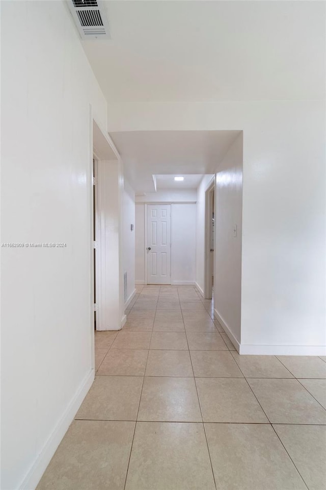 hall featuring light tile patterned floors