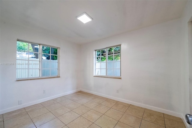 unfurnished room with light tile patterned floors