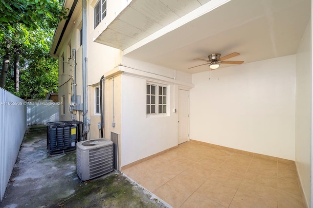 view of side of property featuring central AC unit, a patio, and ceiling fan