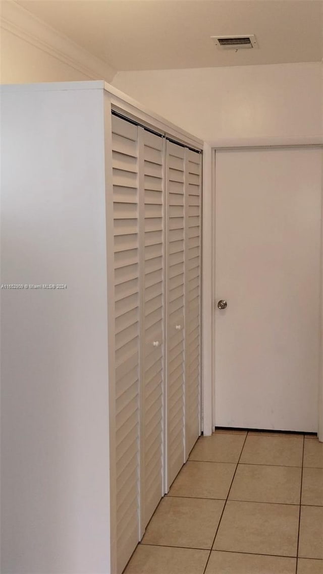 corridor with light tile patterned flooring