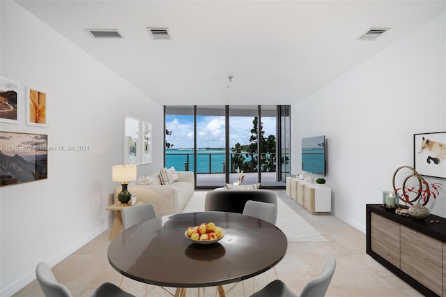 living room with floor to ceiling windows and light tile patterned floors