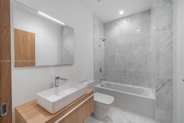 full bathroom featuring vanity, toilet, and tiled shower / bath