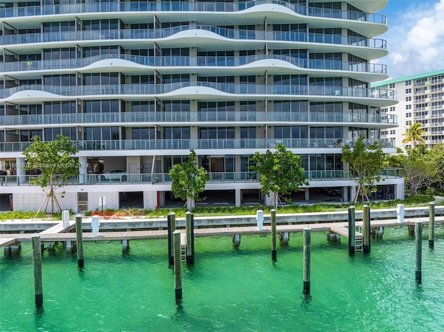 view of pool with a water view and a boat dock