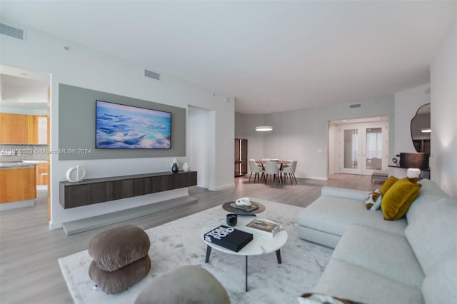 living room with french doors and hardwood / wood-style floors