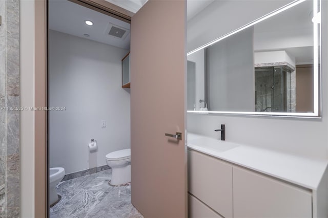 bathroom featuring a bidet, vanity, toilet, and an enclosed shower