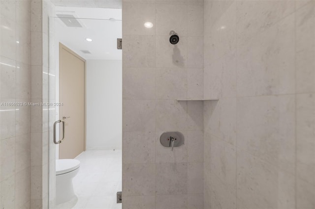 bathroom with toilet and an enclosed shower