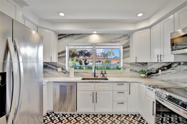 kitchen featuring white cabinets, stainless steel appliances, and sink