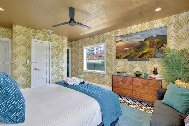 carpeted bedroom with a textured ceiling and ceiling fan