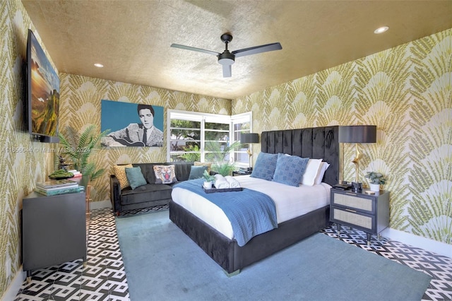 bedroom featuring ceiling fan, a textured ceiling, and carpet floors