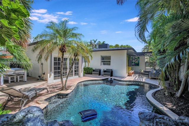 view of pool featuring a patio area and french doors