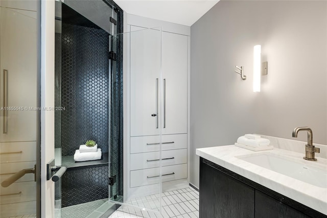 bathroom with tile patterned flooring, vanity, and a shower with door