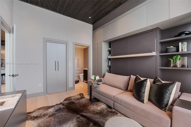 living room with built in features and light wood-type flooring