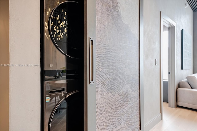 interior space featuring light hardwood / wood-style floors and stacked washer and clothes dryer