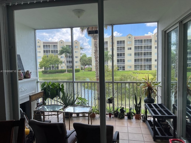 sunroom / solarium featuring a water view