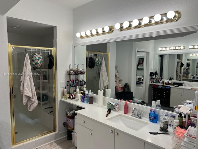 bathroom featuring vanity and a shower with door