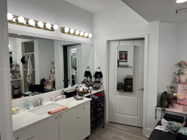 bathroom featuring vanity and hardwood / wood-style floors