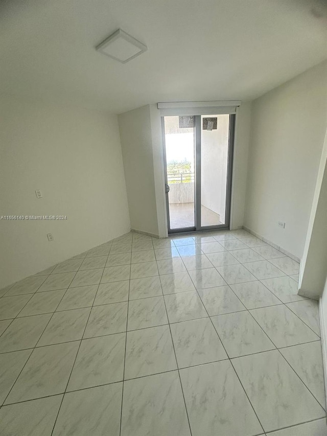 spare room with light tile patterned floors