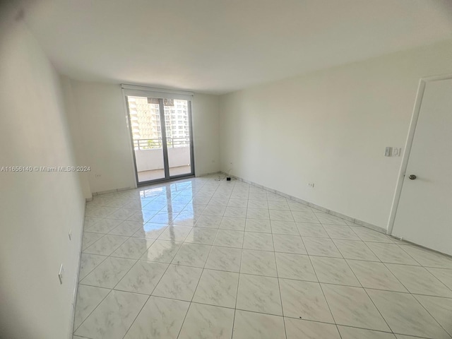 spare room with light tile patterned flooring