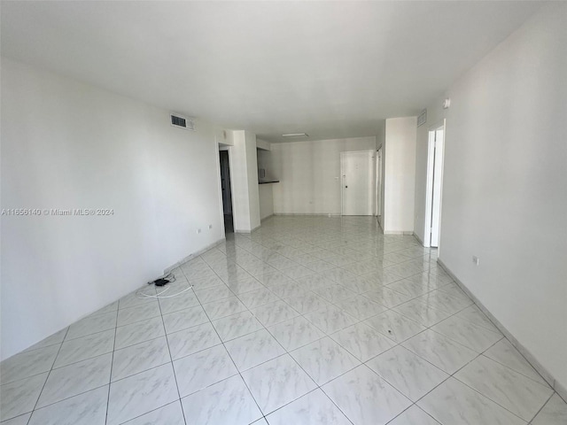 spare room with light tile patterned floors