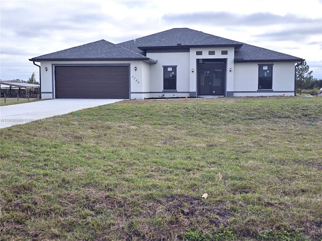 view of front of home featuring a garage and a front yard