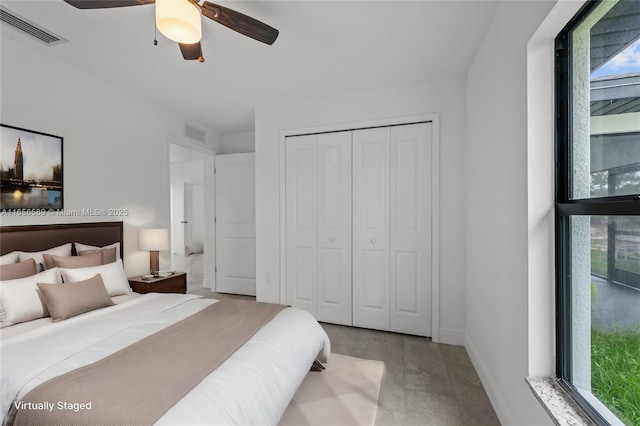 bedroom featuring ceiling fan, a closet, and multiple windows