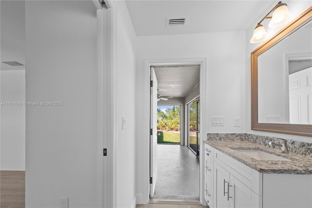 bathroom featuring ceiling fan and vanity