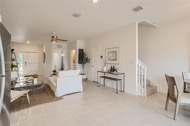 living room with ceiling fan and light tile patterned floors