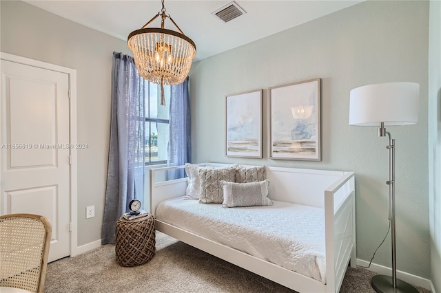 carpeted bedroom with a chandelier