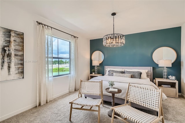 carpeted bedroom featuring an inviting chandelier