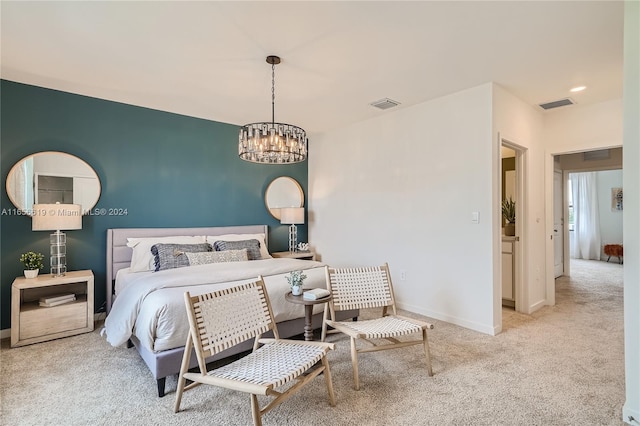 carpeted bedroom featuring an inviting chandelier