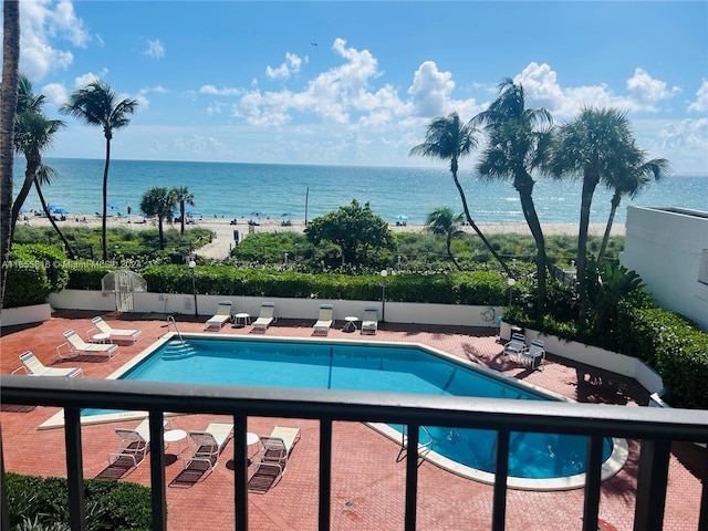 view of swimming pool with a patio and a water view