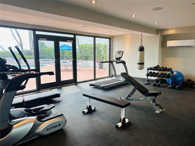 exercise room with french doors and a wall unit AC