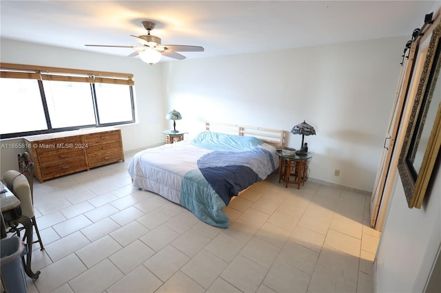 tiled bedroom featuring ceiling fan