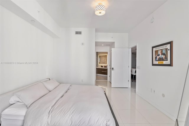 tiled bedroom featuring connected bathroom