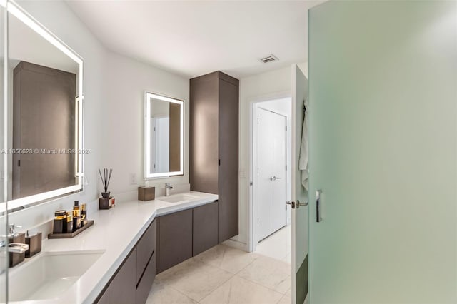 bathroom with tile patterned floors and vanity