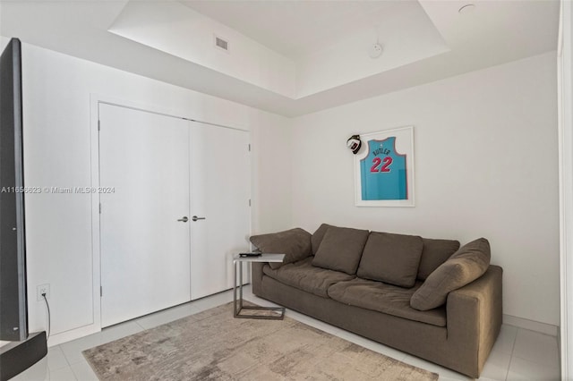 tiled living room with a raised ceiling