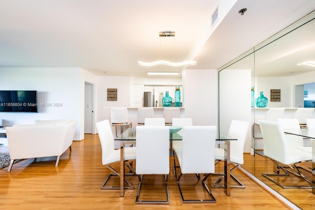 dining space featuring light hardwood / wood-style floors