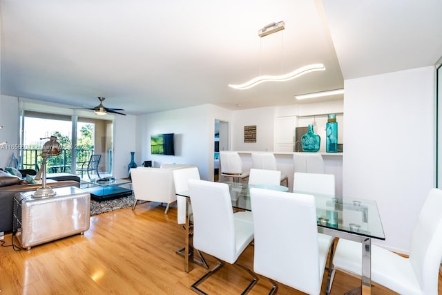 dining area featuring ceiling fan and light hardwood / wood-style floors