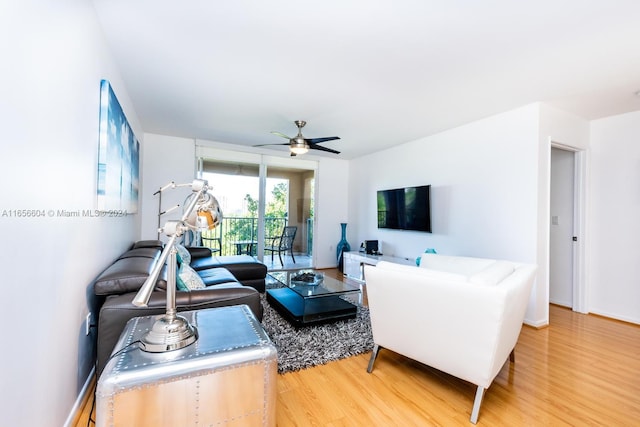 living room featuring ceiling fan and hardwood / wood-style floors