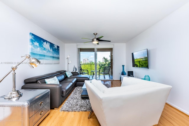 living room with ceiling fan and light wood-type flooring