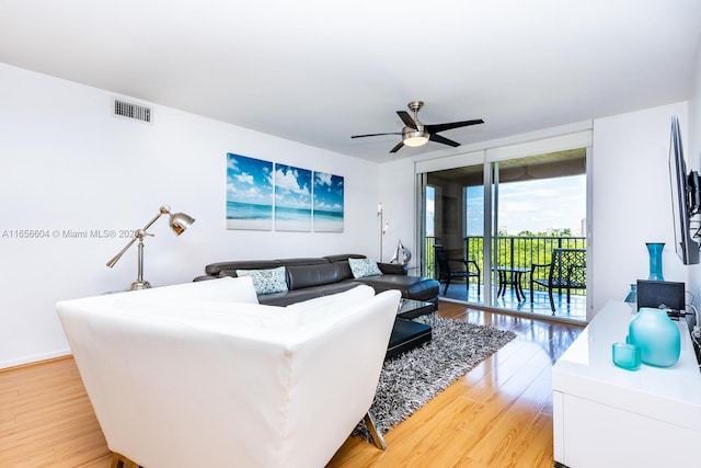 living room with ceiling fan and light hardwood / wood-style floors