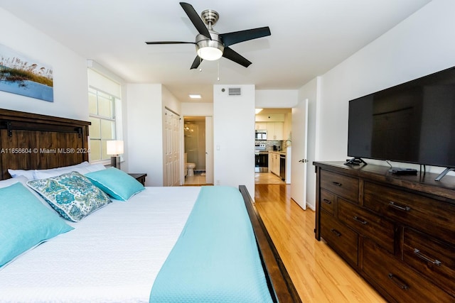 bedroom featuring ceiling fan, connected bathroom, and light hardwood / wood-style flooring