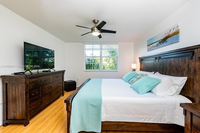 bedroom with light hardwood / wood-style flooring and ceiling fan