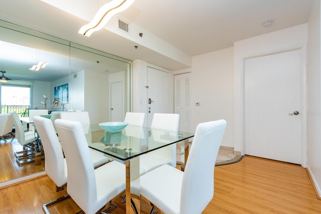 dining area featuring light wood-type flooring and ceiling fan