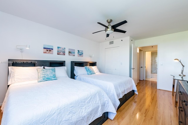 bedroom with a closet, ceiling fan, and light hardwood / wood-style floors